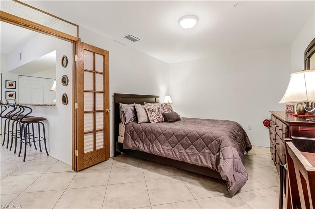 20301 Estero Gardens Circle, Unit 104 Estero, FL 33928 - Photo 19 of 43 a bed room with a bed and a window