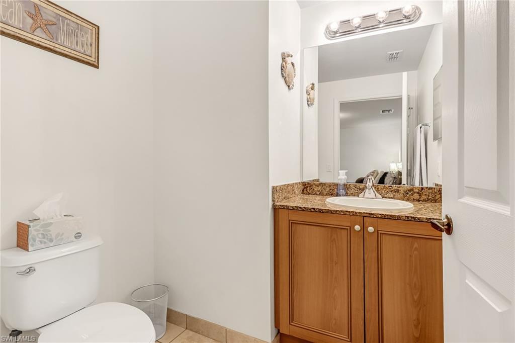20301 Estero Gardens Circle, Unit 104 Estero, FL 33928 - Photo 20 of 43 a bathroom with a sink and a toilet