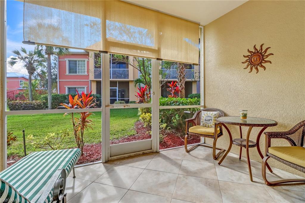20301 Estero Gardens Circle, Unit 104 Estero, FL 33928 - Photo 21 of 43 a view of a chairs and table in a yard