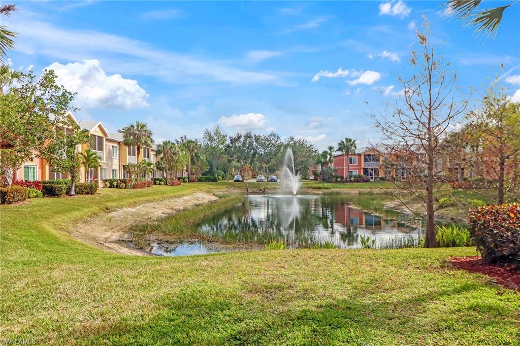 20301 Estero Gardens Circle, Unit 104 Estero, FL 33928 - Photo 24 of 43 a view of a lake with a building in the background