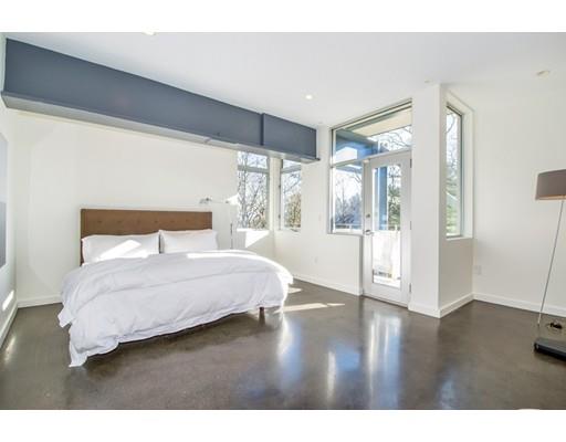 8 Bird Hill Road Lexington, MA 02421 - Photo 17 of 30 a bedroom with a large bed and wooden floor