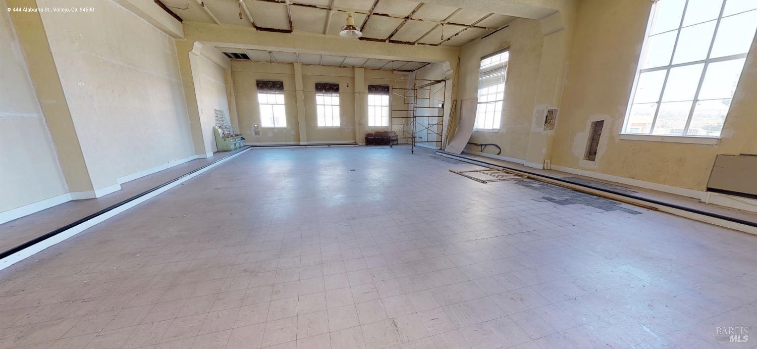 444 Alabama Street Vallejo, CA 94590 - Photo 9 of 23 an empty room with wooden floor and windows