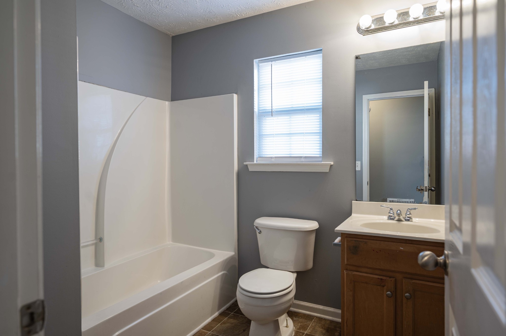 3039 Ridgewood Drive Christiana, TN 37037 - Photo 18 of 20 a bathroom with a sink toilet vanity and tub