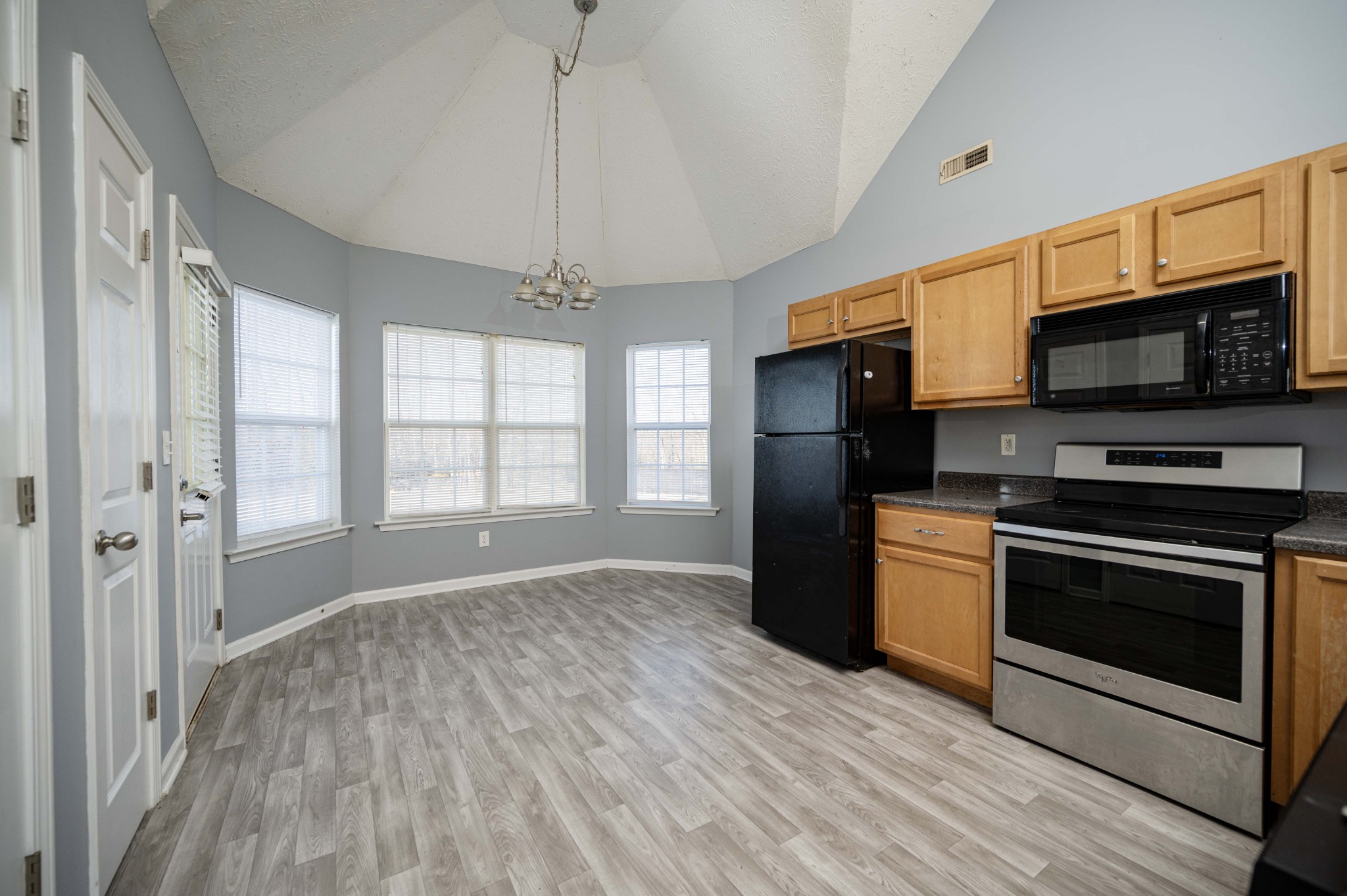 3039 Ridgewood Drive Christiana, TN 37037 - Photo 9 of 20 a kitchen with stainless steel appliances granite countertop a refrigerator microwave and stove top oven