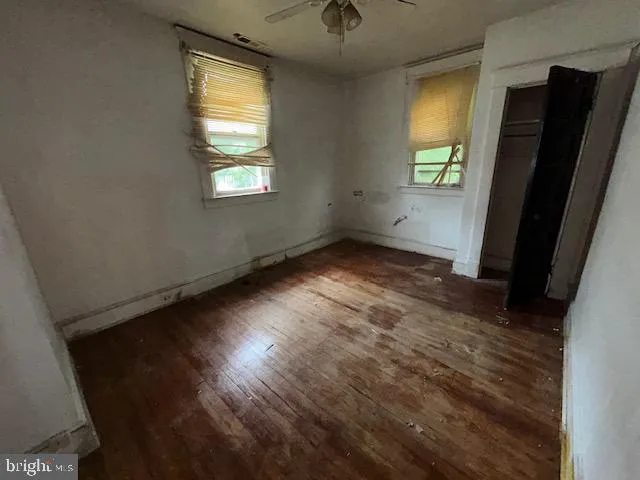 wooden floor in an empty room with a window