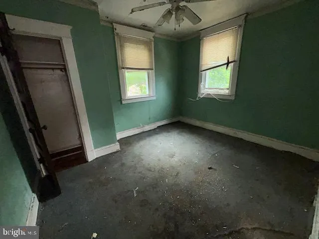 an empty room with windows and closet