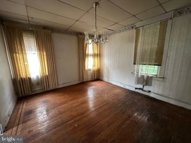 a view of a room with wooden floor and windows