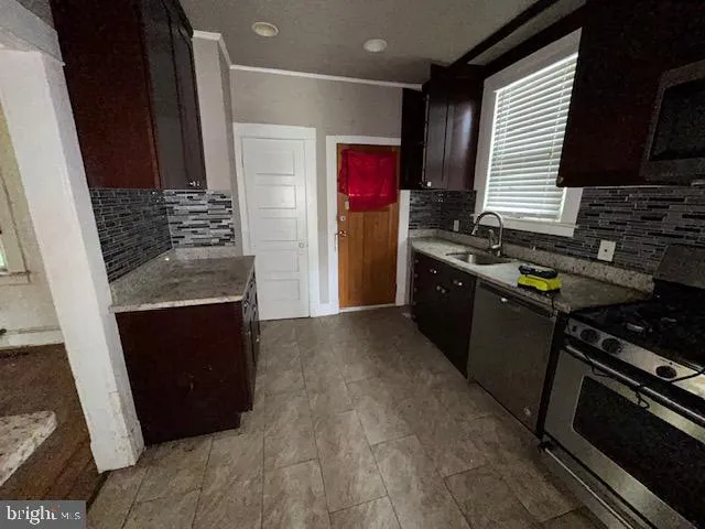 a kitchen with granite countertop stainless steel appliances and wooden cabinets