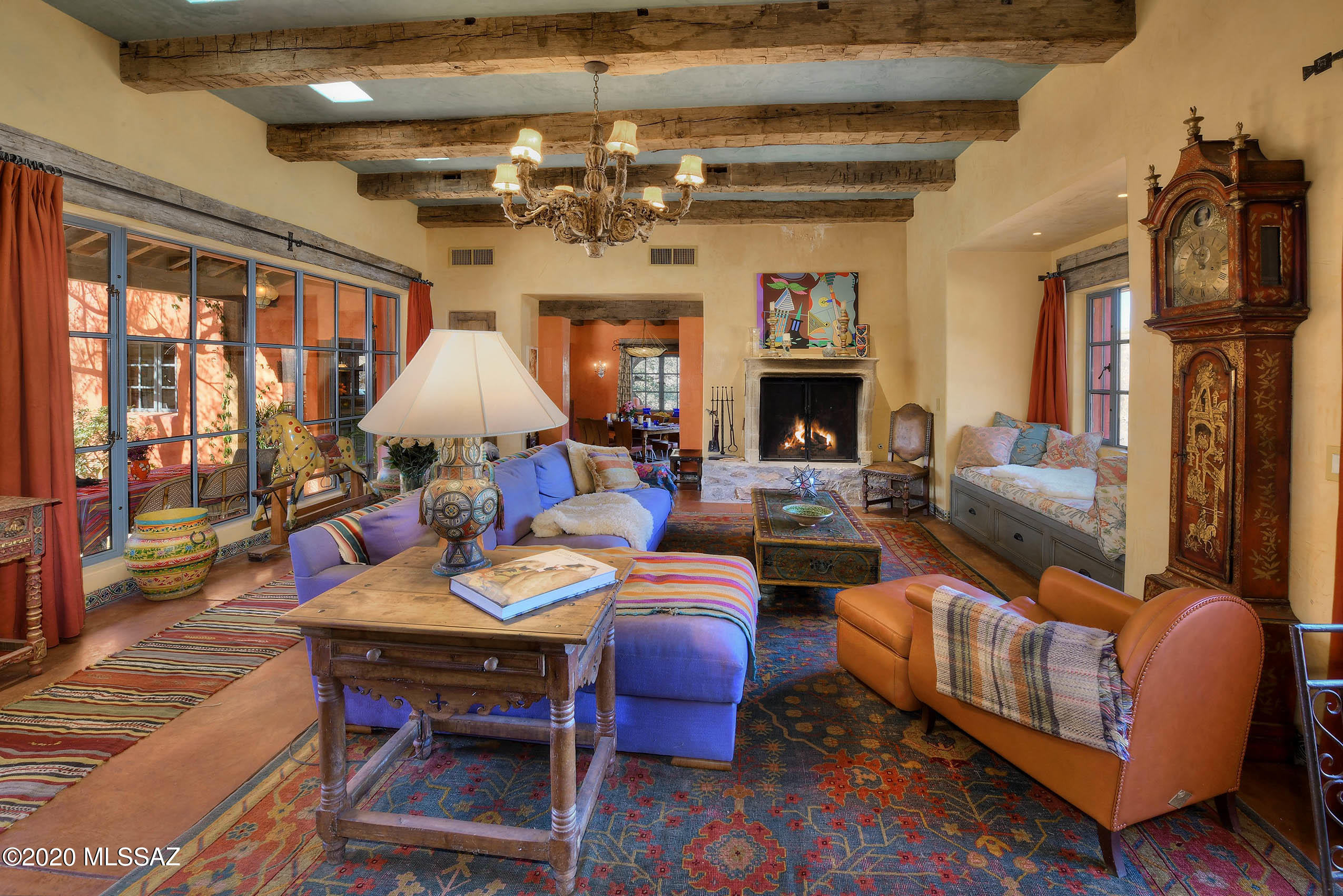 360 Harshaw Creek Road Patagonia, AZ 85624 - Photo 18 of 50 a living room with furniture a fireplace and a chandelier