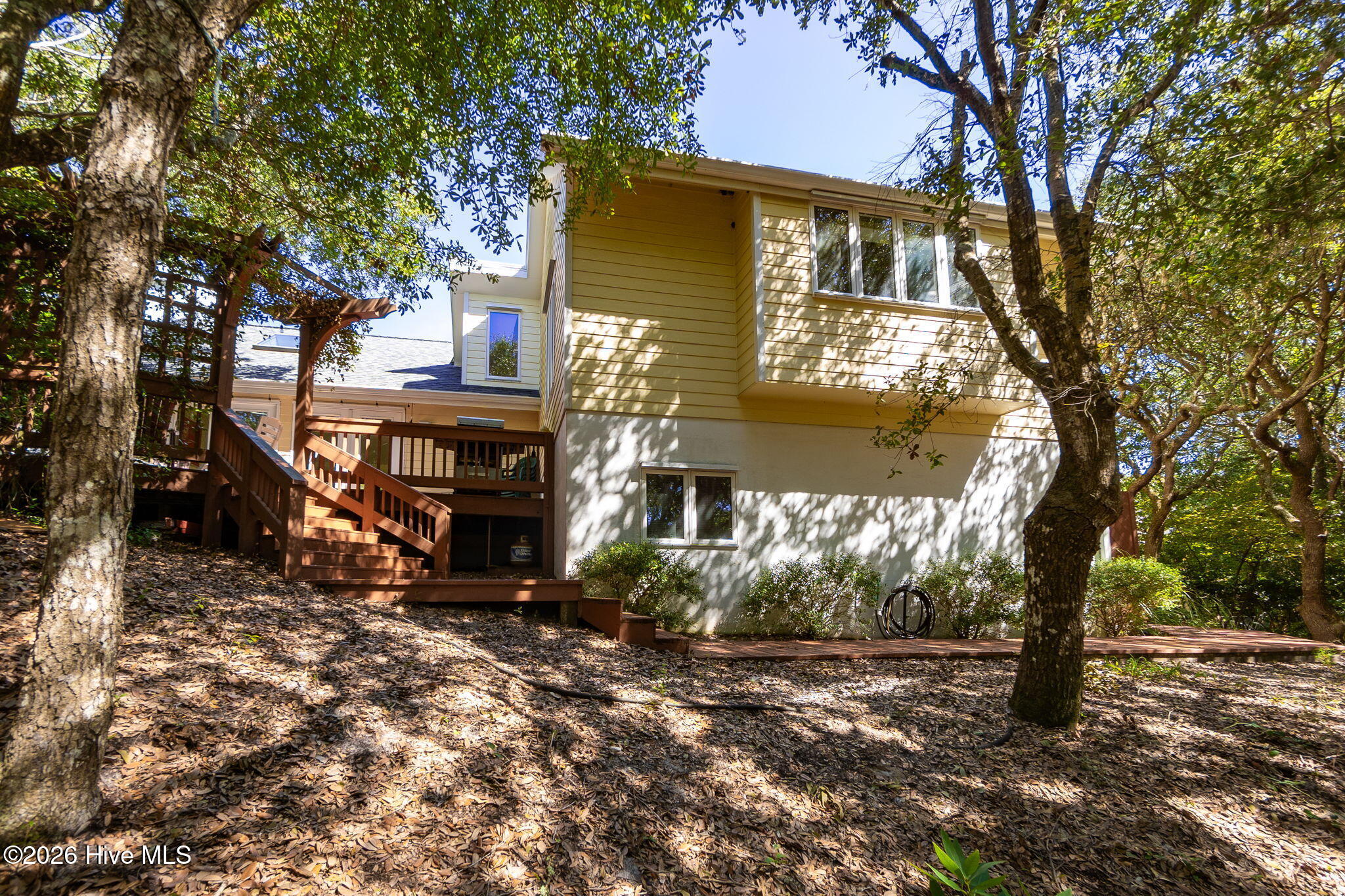 579 Coral Ridge Road Pine Knoll Shores, NC 28512 - Photo 43 of 67 Rear Exterior in Wooded Setting