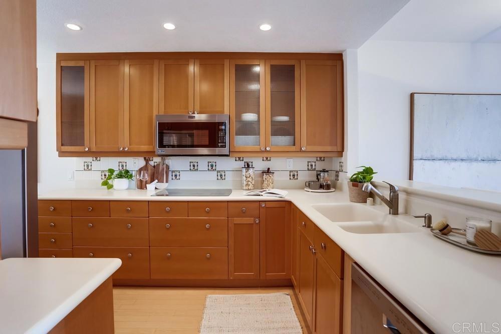 1520 Via Risa San Marcos, CA 92078 - Photo 12 of 34 a kitchen with kitchen island granite countertop a sink counter top space and cabinets