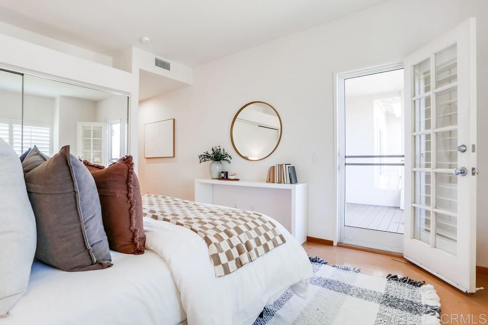 1520 Via Risa San Marcos, CA 92078 - Photo 21 of 34 a bedroom with a bed lamp closet and large window