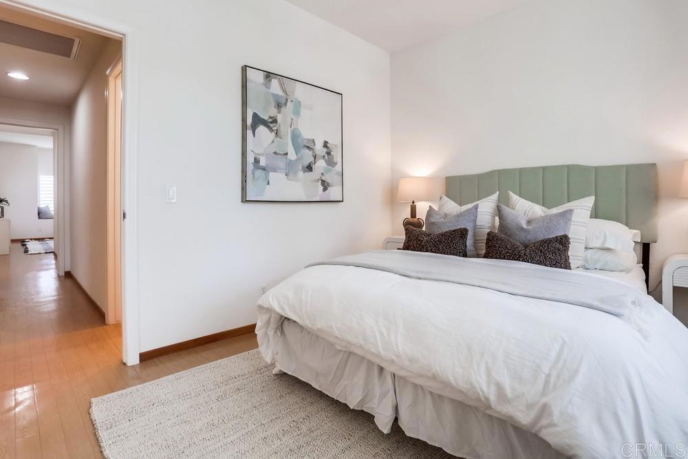 1520 Via Risa San Marcos, CA 92078 - Photo 27 of 34 a large bed sitting in a bedroom and a table