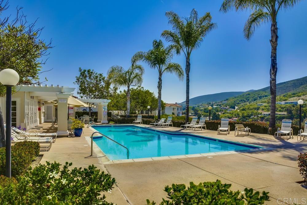 1520 Via Risa San Marcos, CA 92078 - Photo 33 of 34 a view of a patio with table and chairs potted plants and palm trees