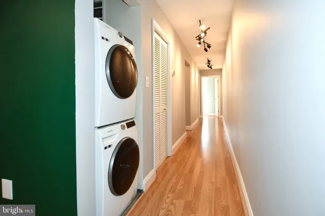 a view of a hallway with washer and dryer