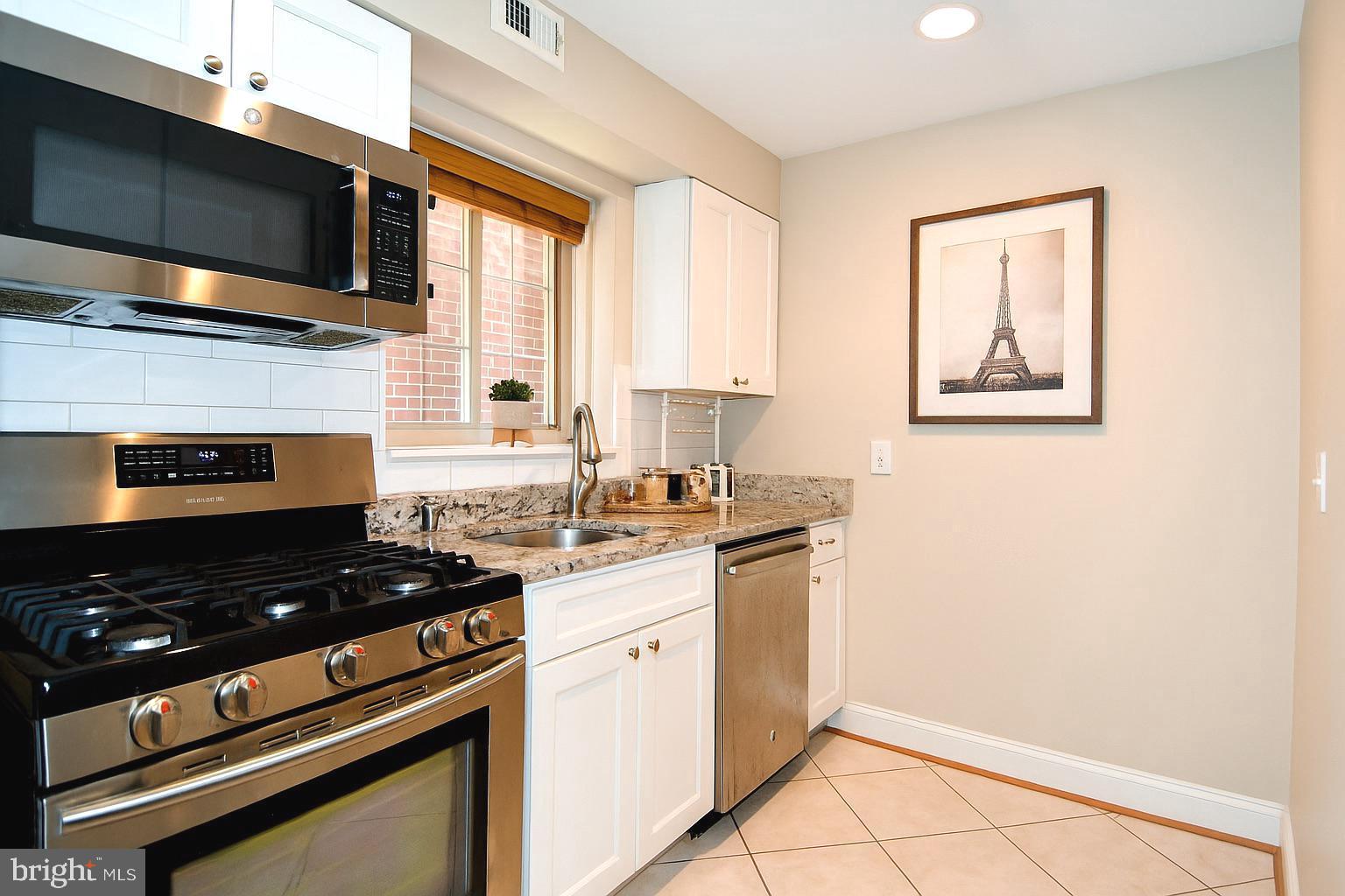 718 Park Road Northwest, Unit 4 Washington, DC 20010 - Photo 3 of 18 a view of a kitchen with electric appliances
