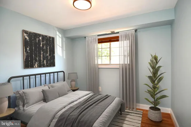 a bedroom with bed and wooden floor