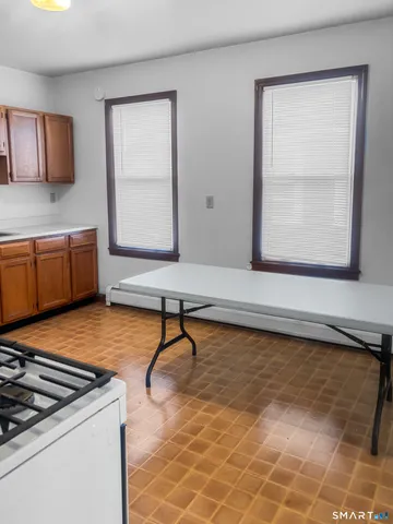 a room with pool table and window