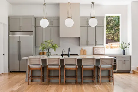 a dining room with furniture and large windows