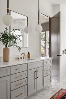 a kitchen with granite countertop white cabinets and window
