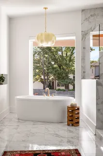 a bathroom with double vanity sinks and a bathtub