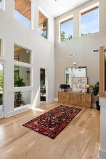 a view of a hallway with wooden floor and a potted plant