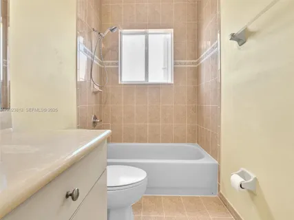a bathroom with a bathtub and a toilet