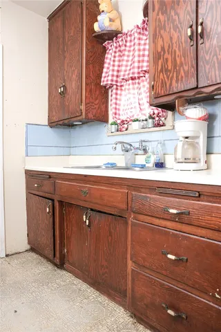 a kitchen with a sink and a mirror