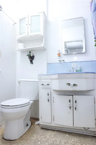 a spacious bathroom with a tub sink and mirror