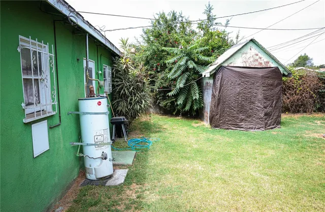 a backyard of a house with table and chairs