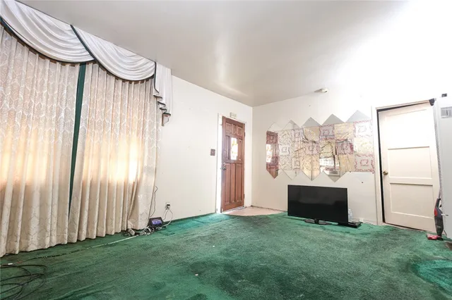 a view of a livingroom with furniture and staircase