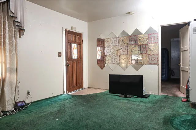 a view of a livingroom with furniture and a flat screen tv