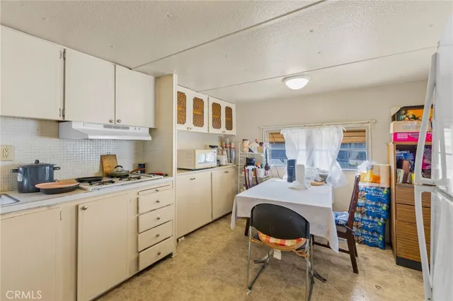 a kitchen with a stove and white cabinets