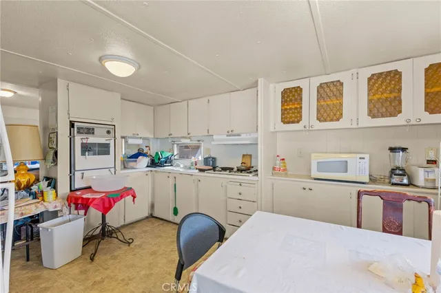 a kitchen with cabinets and window