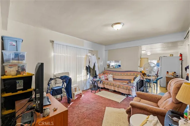 a livingroom with workspace and a couch