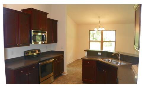 88480 Maybourne Road Yulee, FL 32097 - Photo 3 of 3 a kitchen that has a sink and cabinets