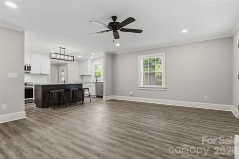 a kitchen with stainless steel appliances granite countertop a stove and a wooden floors