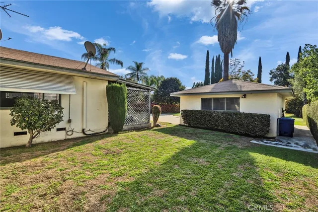 a view of backyard with plants and outdoor seating