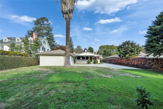 a view of an empty room with a fireplace and a window