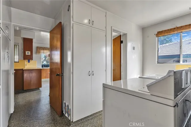 a room with large window and chandelier
