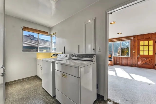 a kitchen with stainless steel appliances granite countertop a sink cabinets and wooden floor
