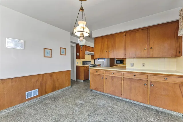 a kitchen with stainless steel appliances granite countertop a stove and a sink