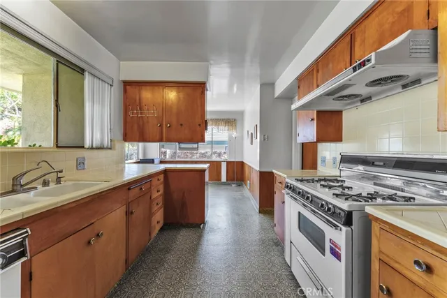 a bathroom with a granite countertop sink mirror and toilet