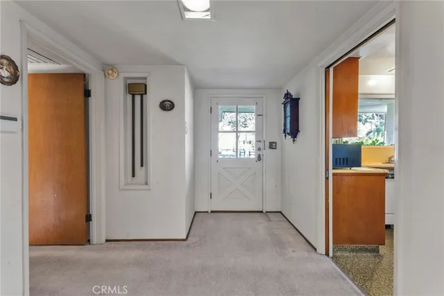 a spacious bedroom with a bed and a dresser with rug