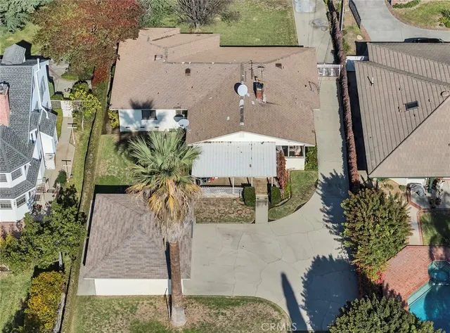 an aerial view of multiple houses with yard