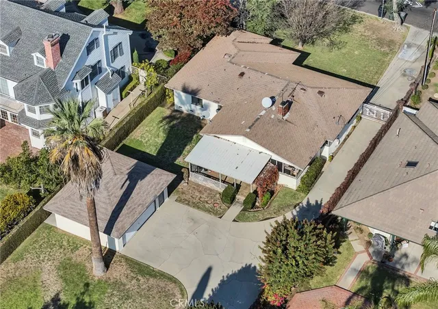 an aerial view of multiple houses with yard