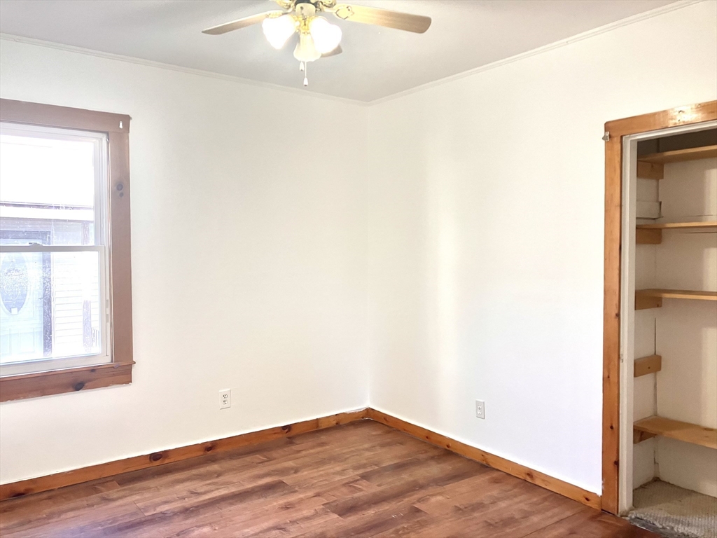 4 Sisson Terrace, Unit 1 Lynn, MA 01902 - Photo 13 of 16 a view of an empty room with wooden floor and a window