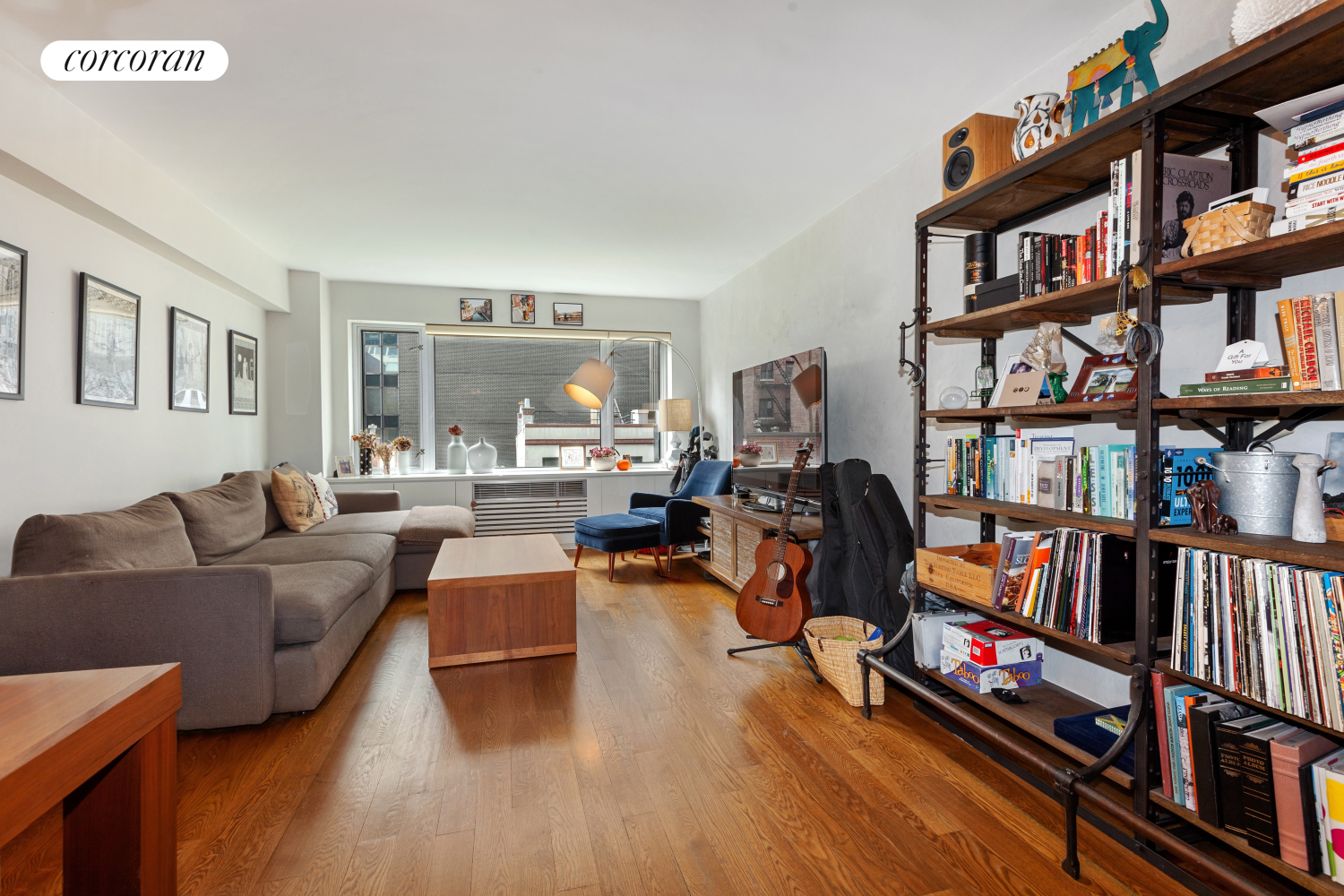 a living room with furniture book shelf and a book shelf