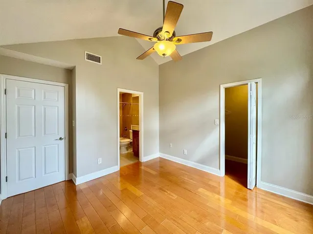 a view of an empty room with wooden floor