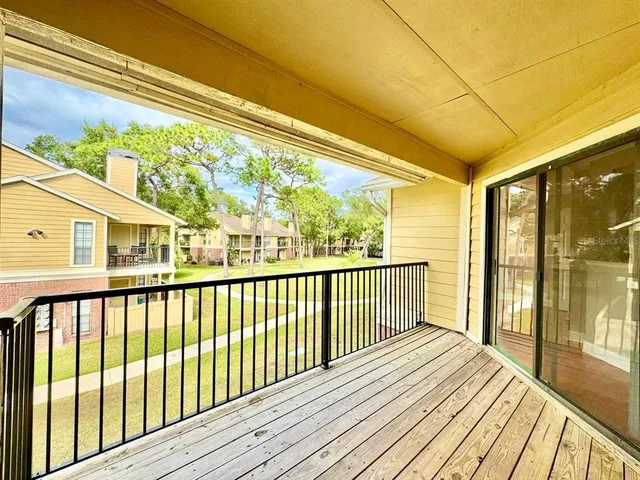 a view of a balcony with wooden floor